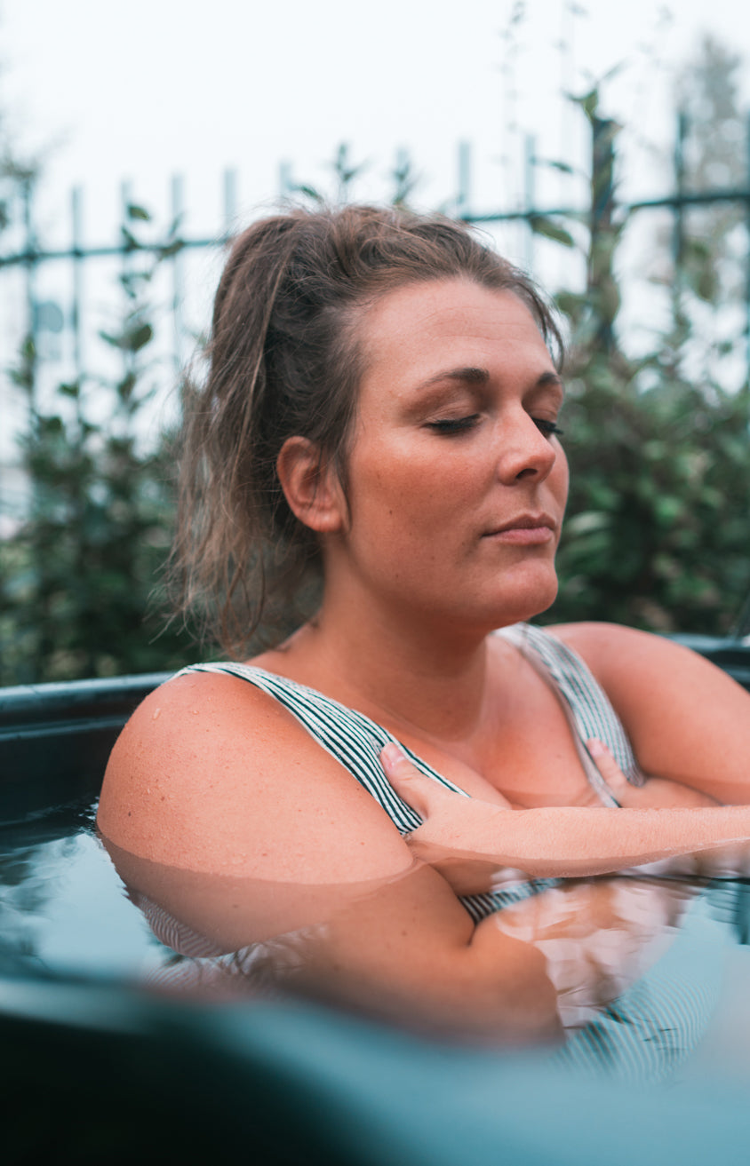 woman taking a cold dip in an icetub